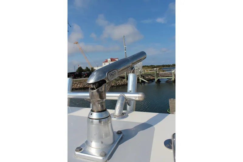 Miss Jennie Yacht Photos Pics Close-up of a 2008 H&H Marine 38 boat's metal fitting against a marina backdrop.