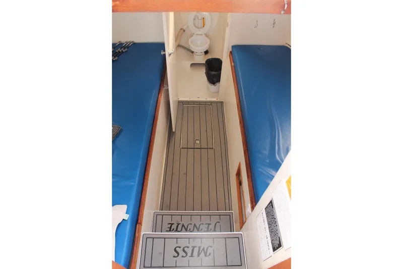 Miss Jennie Yacht Photos Pics 2008 H&H Marine 38 interior with blue cushioned bunks and compact bathroom.