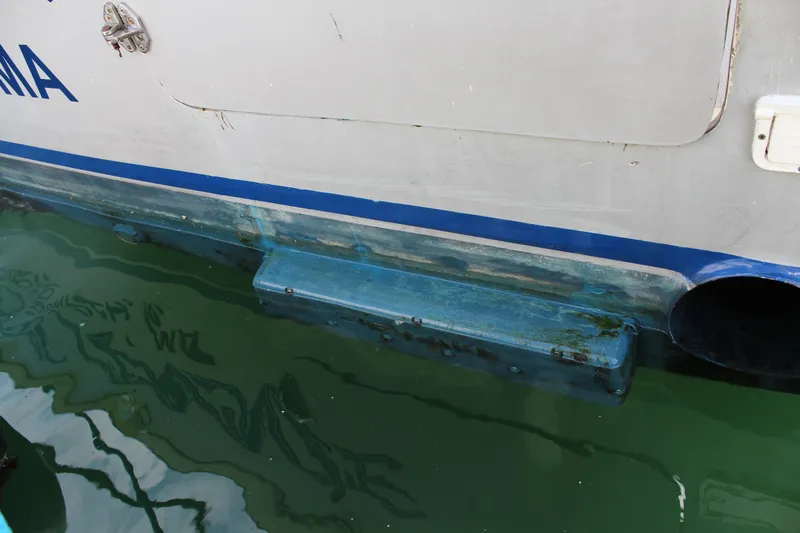 Miss Jennie Yacht Photos Pics 2008 H&H Marine 38 boat hull with blue trim in water.