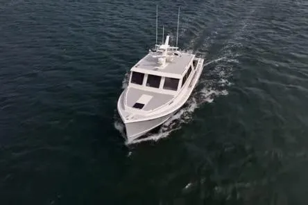 Miss Jennie Yacht Photos Pics 2008 H&H Marine 38 boat cruising on open water, aerial view.