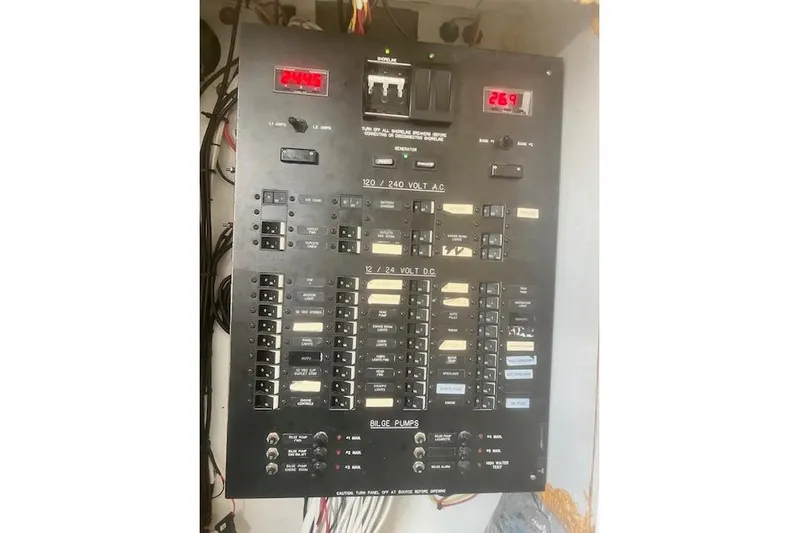 Miss Jennie Yacht Photos Pics Electrical panel of a 2008 H&H Marine 38 boat, featuring voltage displays and circuit breakers.