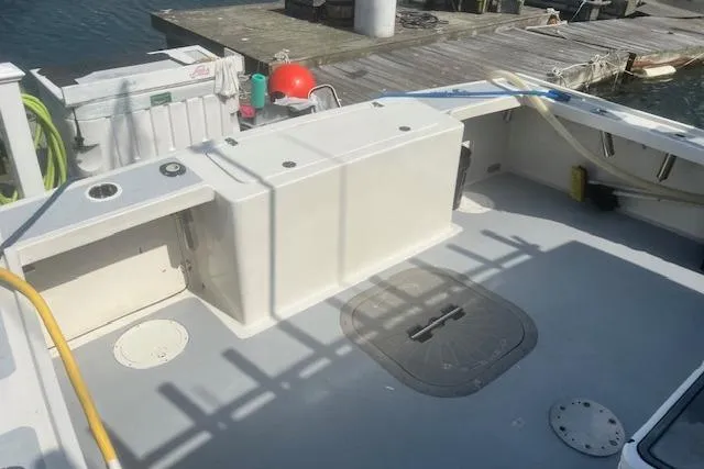 Miss Jennie Yacht Photos Pics 2008 H&H Marine 38 boat deck with storage compartments, docked at a marina.