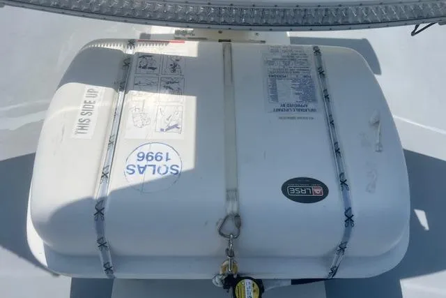 Miss Jennie Yacht Photos Pics Life raft on 2008 H&H Marine 38 boat deck, secured with straps.
