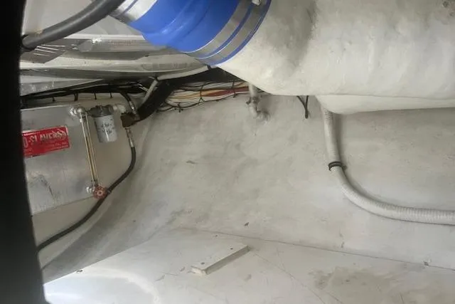 Miss Jennie Yacht Photos Pics Engine compartment of a 2008 H&H Marine 38 boat, showing wiring and hoses.