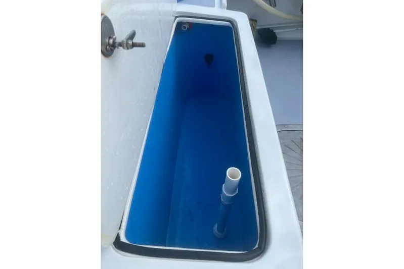 Miss Jennie Yacht Photos Pics Livewell on 2008 H&H Marine 38 boat, featuring blue interior and plumbing.