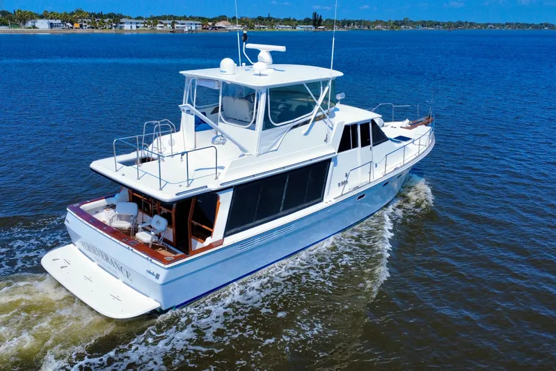 Perseverance Yacht Photos Pics 1989 Bayliner 4588 Motoryacht cruising on a sunny day, showcasing sleek design and spacious deck.