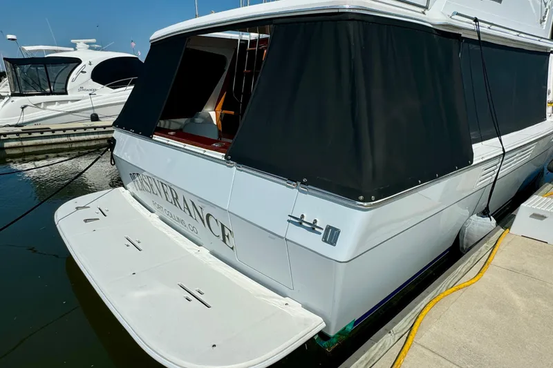 Perseverance Yacht Photos Pics 1989 Bayliner 4588 Motoryacht docked, featuring black canvas covers and swim platform.