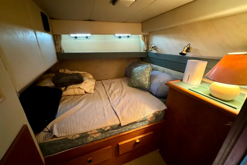 Perseverance Yacht Photos Pics Cozy bedroom in 1989 Bayliner 4588 Motoryacht with bed, pillows, and ambient lighting.