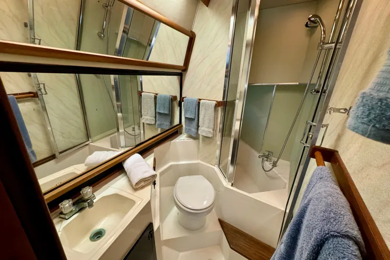 Perseverance Yacht Photos Pics 1989 Bayliner 4588 Motoryacht bathroom with shower, sink, and towels.