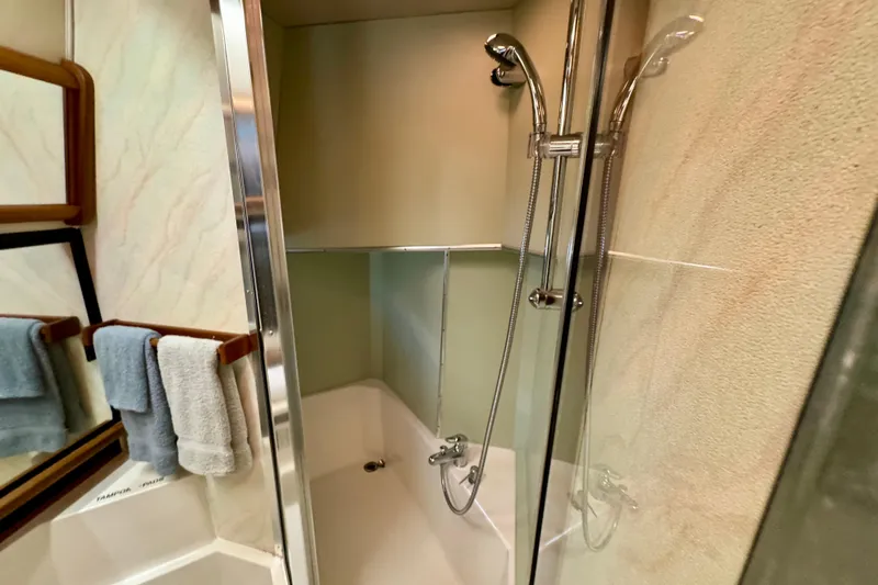 Perseverance Yacht Photos Pics Shower area in 1989 Bayliner 4588 Motoryacht with glass door and chrome fixtures.