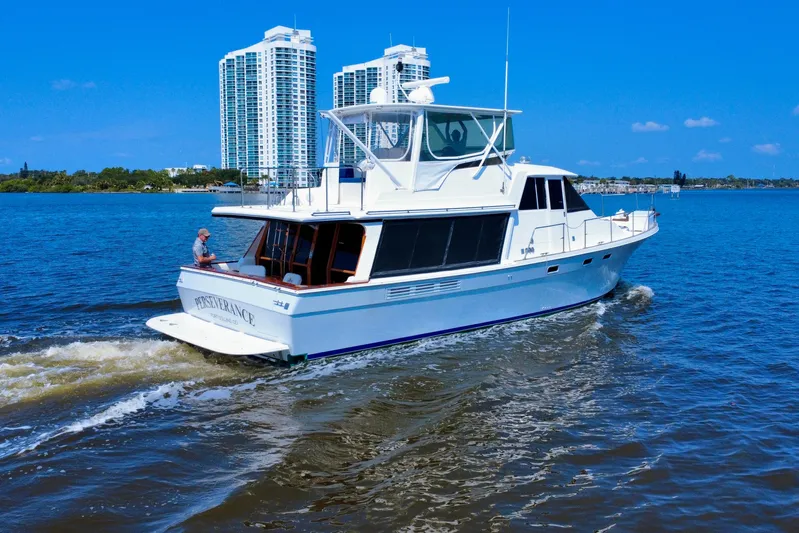 Perseverance Yacht Photos Pics 1989 Bayliner 4588 Motoryacht cruising on a sunny day with city skyline backdrop.