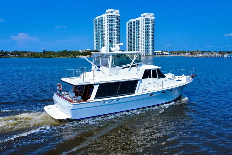 Perseverance Yacht Photos Pics 1989 Bayliner 4588 Motoryacht cruising on a sunny day with city skyline backdrop.
