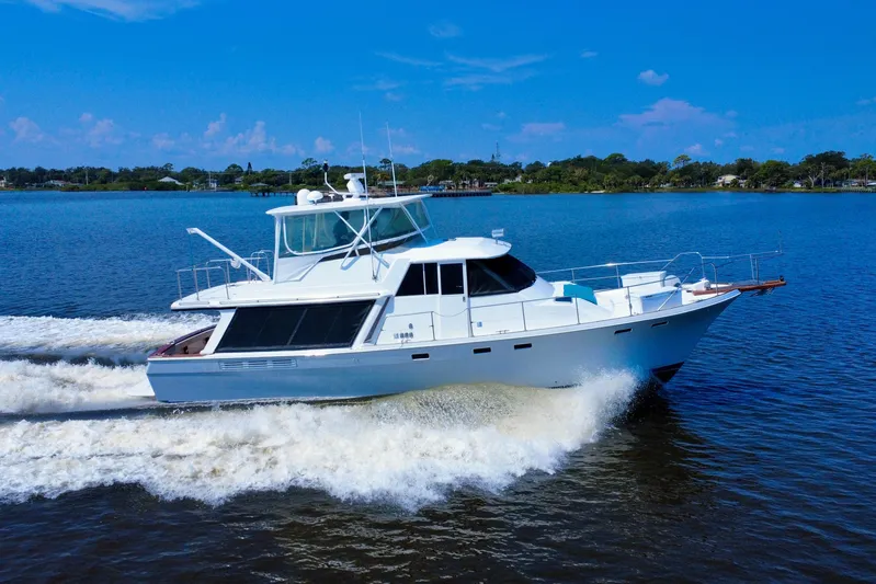 Perseverance Yacht Photos Pics 1989 Bayliner 4588 Motoryacht cruising on a serene blue lake under a clear sky.