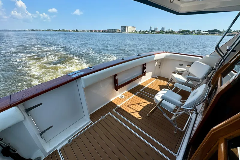 Perseverance Yacht Photos Pics 1989 Bayliner 4588 Motoryacht deck with chairs, cruising on a sunny day.