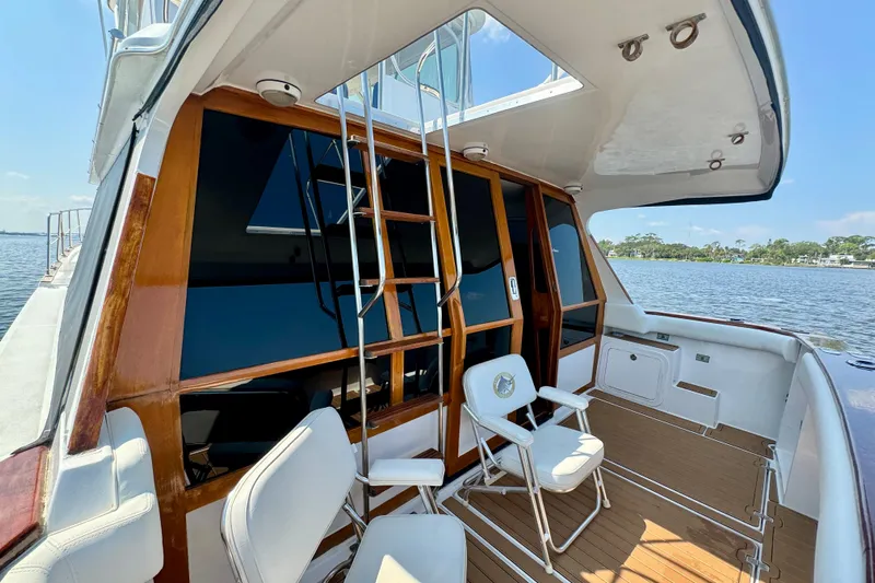 Perseverance Yacht Photos Pics 1989 Bayliner 4588 Motoryacht deck with chairs, ladder, and scenic water view.