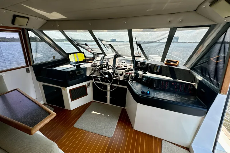Perseverance Yacht Photos Pics 1989 Bayliner 4588 Motoryacht helm with navigation equipment and panoramic water views.