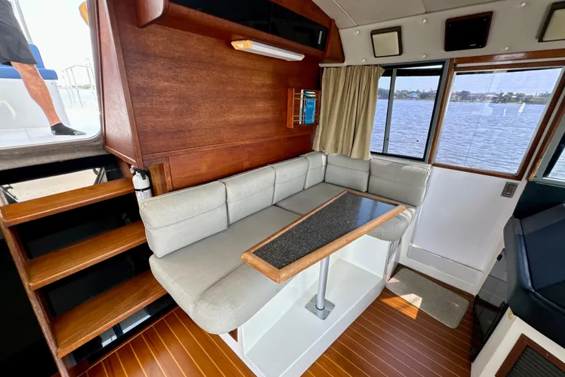 Perseverance Yacht Photos Pics 1989 Bayliner 4588 Motoryacht interior with seating, table, and scenic water view.