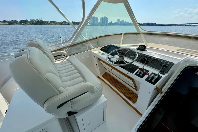 Perseverance Yacht Photos Pics 1989 Bayliner 4588 Motoryacht helm with white captain's chair and panoramic water view.
