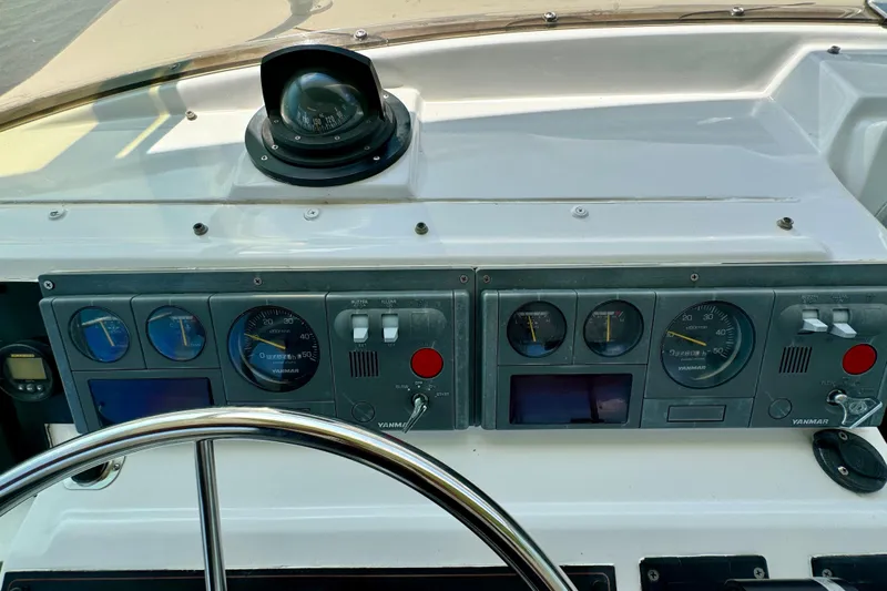 Perseverance Yacht Photos Pics 1989 Bayliner 4588 Motoryacht dashboard with gauges, compass, and steering wheel.
