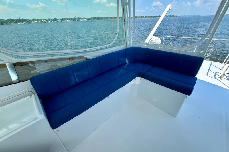 Perseverance Yacht Photos Pics 1989 Bayliner 4588 Motoryacht interior with blue seating and scenic water view.