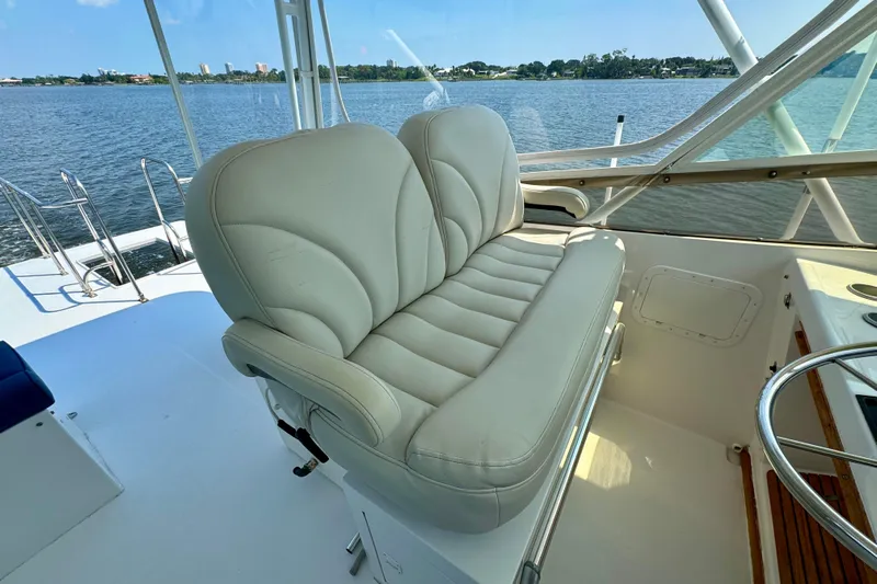 Perseverance Yacht Photos Pics 1989 Bayliner 4588 Motoryacht helm with white leather seating, overlooking serene water.