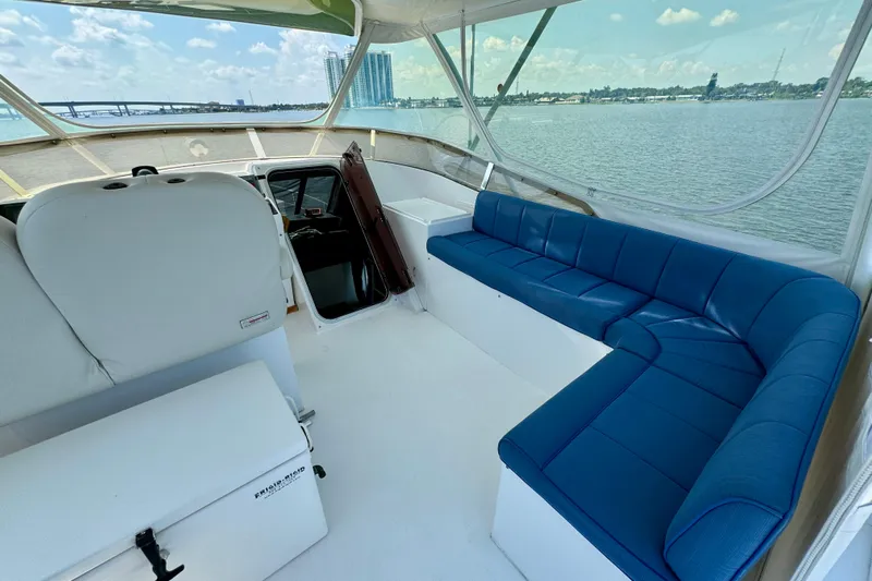 Perseverance Yacht Photos Pics 1989 Bayliner 4588 Motoryacht interior with blue seating, overlooking scenic waterfront.