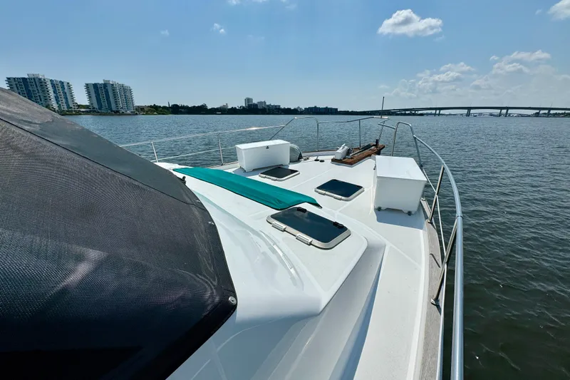 Perseverance Yacht Photos Pics 1989 Bayliner 4588 Motoryacht on water, cityscape and bridge in background.