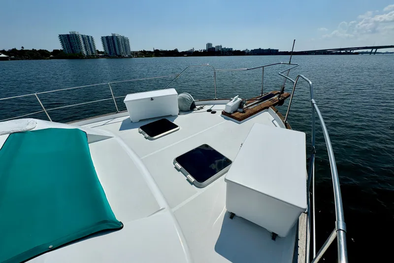 Perseverance Yacht Photos Pics 1989 Bayliner 4588 Motoryacht on calm water with city skyline in background.