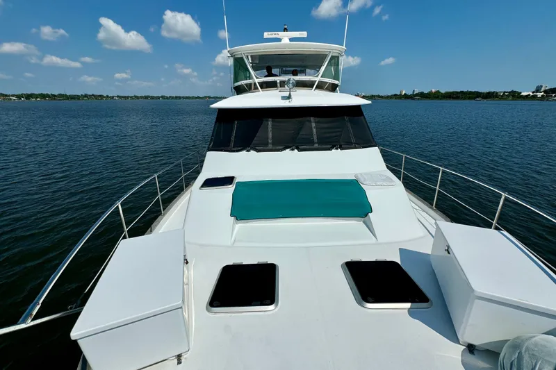 Perseverance Yacht Photos Pics 1989 Bayliner 4588 Motoryacht on calm water under blue sky with clouds.