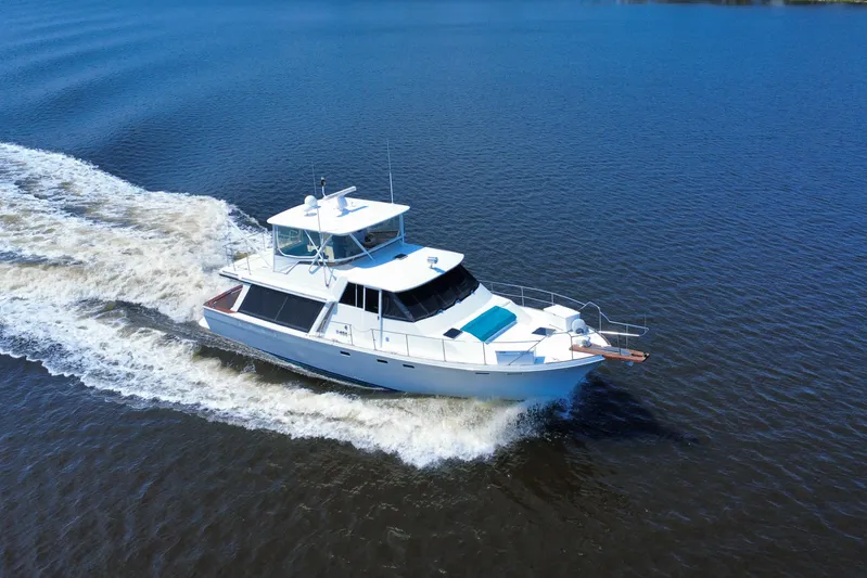 Perseverance Yacht Photos Pics 1989 Bayliner 4588 Motoryacht cruising on open water, aerial view.