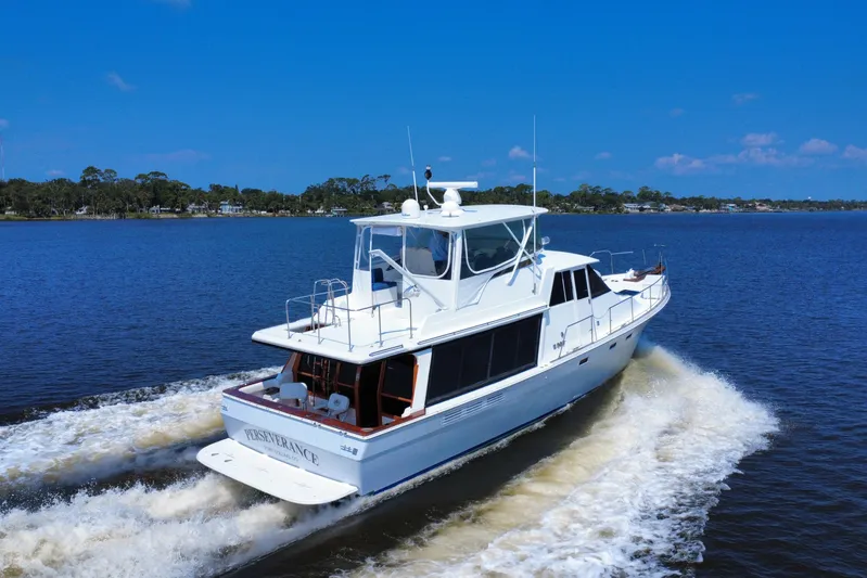 Perseverance Yacht Photos Pics 1989 Bayliner 4588 Motoryacht cruising on a calm blue lake under clear skies.