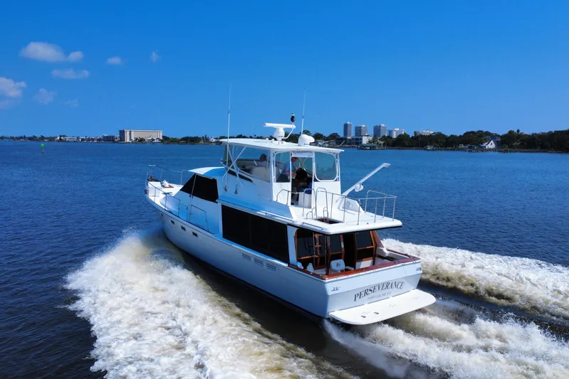 Perseverance Yacht Photos Pics 1989 Bayliner 4588 Motoryacht cruising on a sunny day, with city skyline in background.