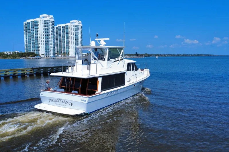 Perseverance Yacht Photos Pics 1989 Bayliner 4588 Motoryacht cruising near waterfront skyscrapers on a sunny day.