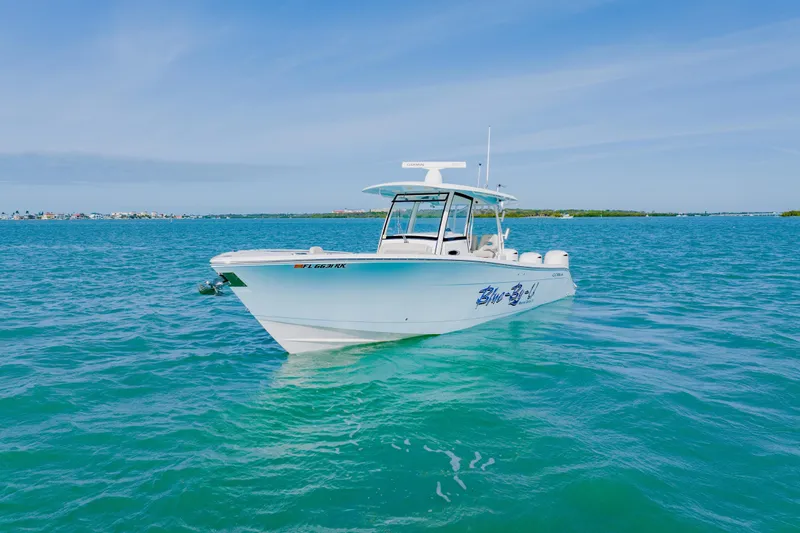  Yacht Photos Pics 2017 Cobia 344 Center Console boat on clear blue water under a sunny sky.