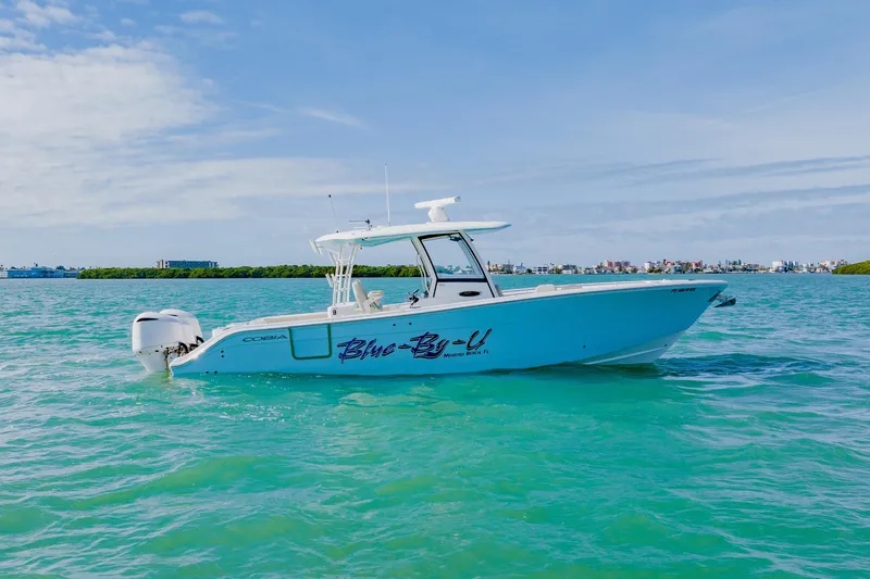  Yacht Photos Pics 2017 Cobia 344 Center Console boat on turquoise water under blue sky.