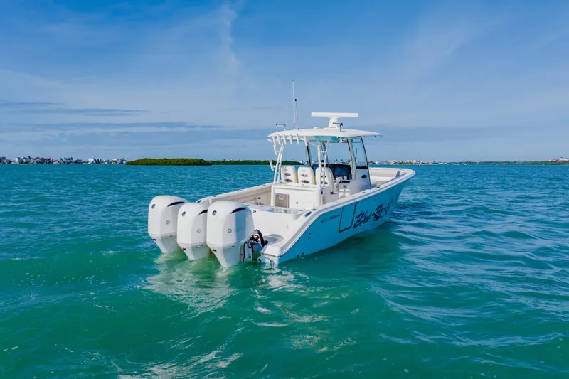  Yacht Photos Pics 2017 Cobia 344 Center Console boat on clear blue water.