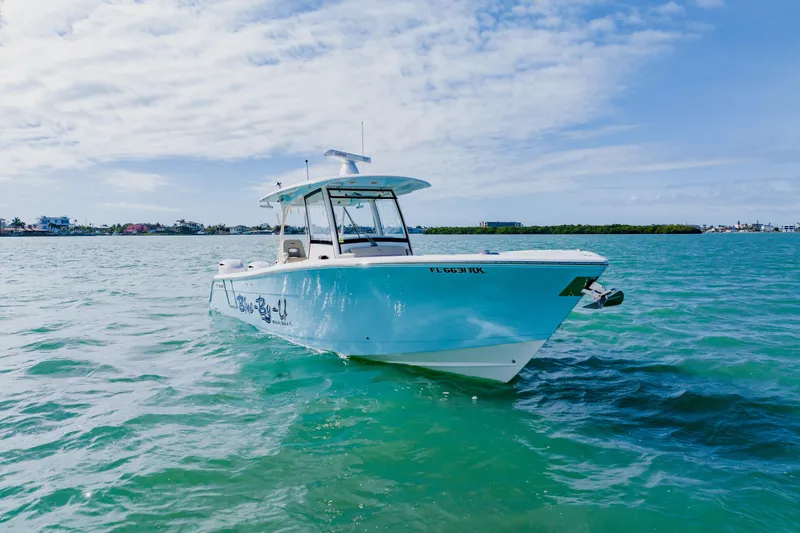  Yacht Photos Pics 2017 Cobia 344 Center Console boat on clear blue water under a partly cloudy sky.