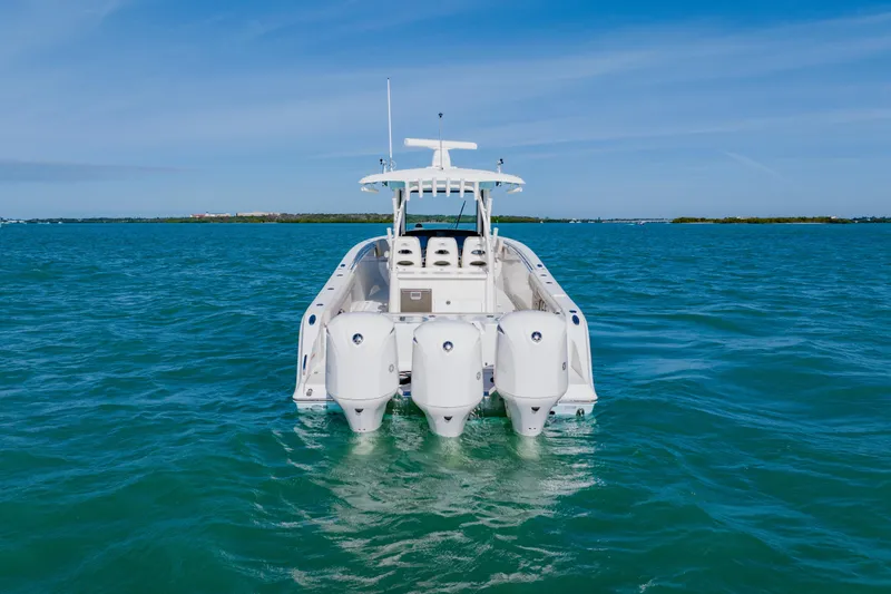  Yacht Photos Pics 2017 Cobia 344 Center Console boat on open water, rear view.