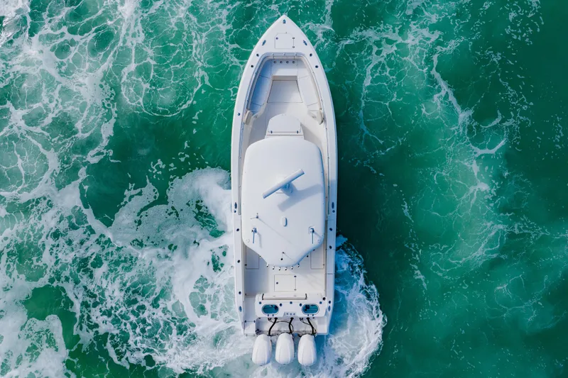  Yacht Photos Pics Aerial view of 2017 Cobia 344 Center Console boat navigating turquoise waters.