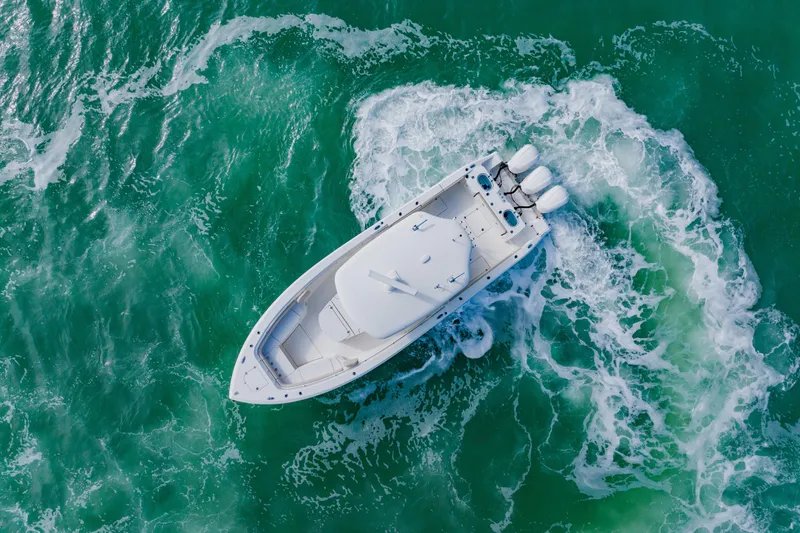  Yacht Photos Pics 2017 Cobia 344 Center Console boat navigating turquoise ocean waters.