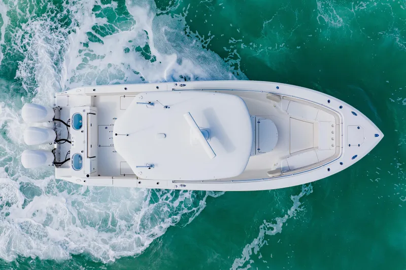  Yacht Photos Pics Overhead view of 2017 Cobia 344 Center Console boat on turquoise water.