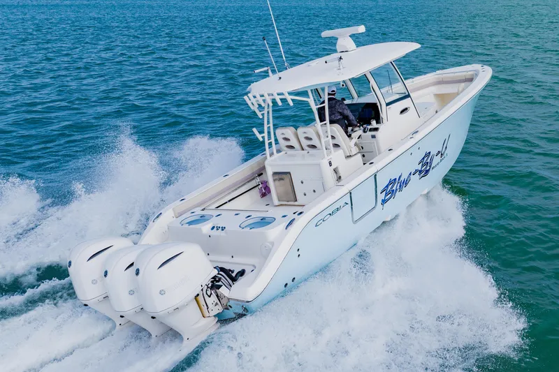  Yacht Photos Pics 2017 Cobia 344 Center Console boat cruising on open water.
