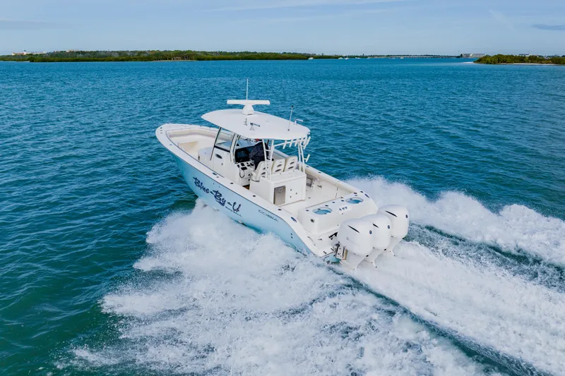  Yacht Photos Pics 2017 Cobia 344 Center Console boat cruising on open water.