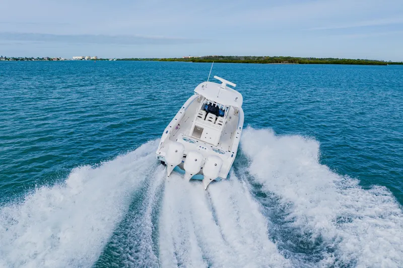  Yacht Photos Pics 2017 Cobia 344 Center Console boat cruising on open blue water.