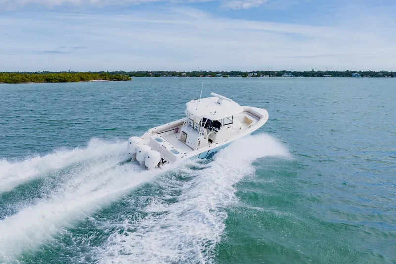  Yacht Photos Pics 2017 Cobia 344 Center Console boat cruising on open water.