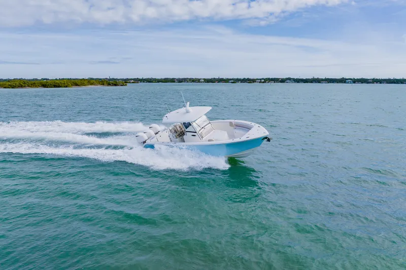  Yacht Photos Pics 2017 Cobia 344 Center Console boat cruising on open water.