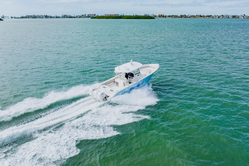  Yacht Photos Pics 2017 Cobia 344 Center Console boat cruising on open water.