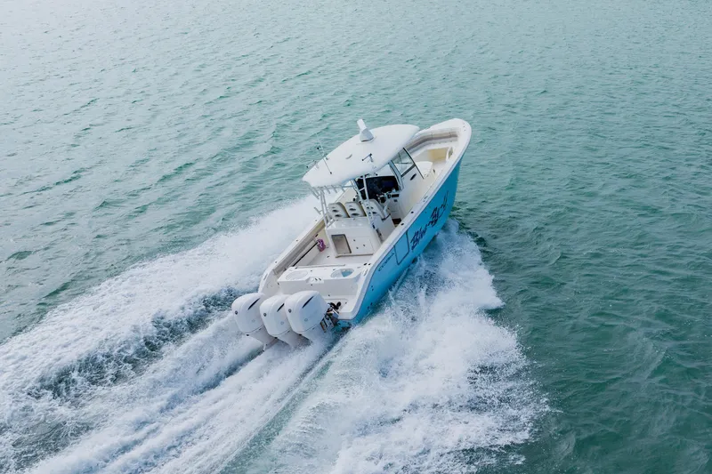  Yacht Photos Pics 2017 Cobia 344 Center Console boat cruising on open water.
