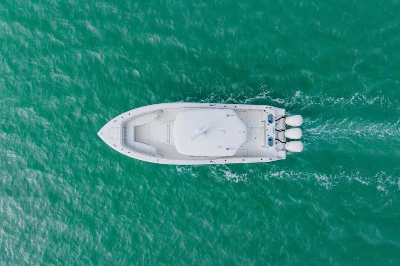  Yacht Photos Pics Aerial view of 2017 Cobia 344 Center Console boat on turquoise water.