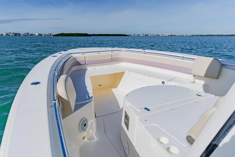  Yacht Photos Pics 2017 Cobia 344 Center Console boat on calm blue waters, featuring spacious seating.